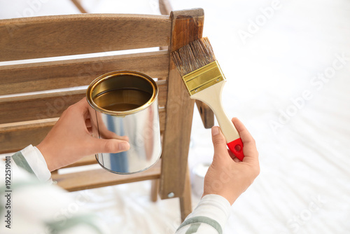 Woman painting garden chair...
