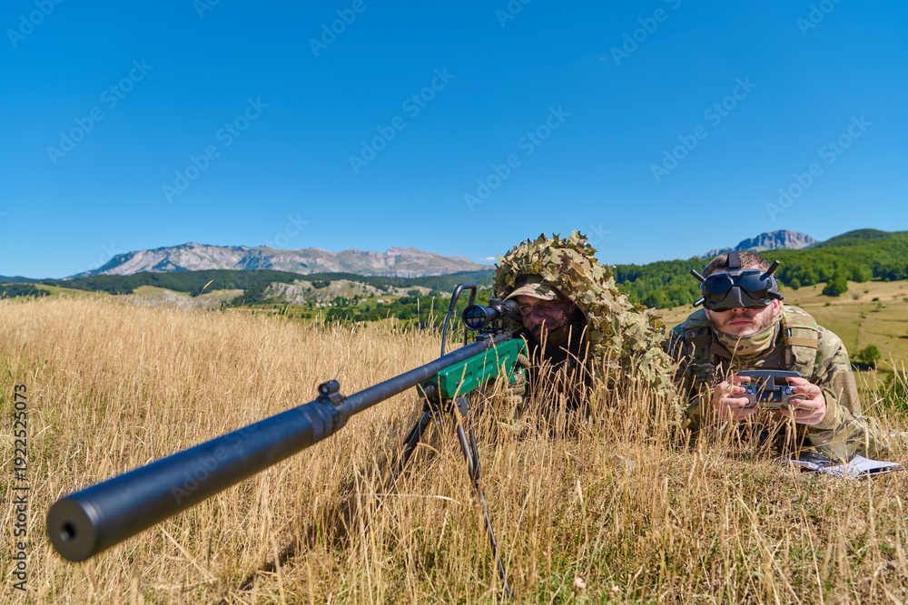 Fototapeta premium Sniper And Spotter Soldiers In Camouflage Prone With Rifle And Optics In Mountain Field