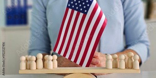 Tableau sur toile A person placing a wooden flag in front of small figures representing a communit