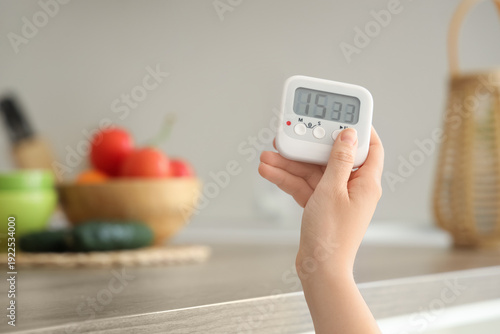 Female hand with kitchen ti...