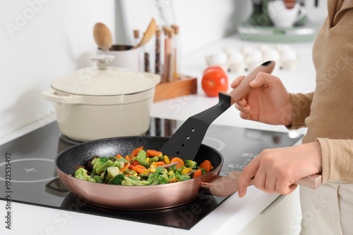 Woman with spatula frying v...
