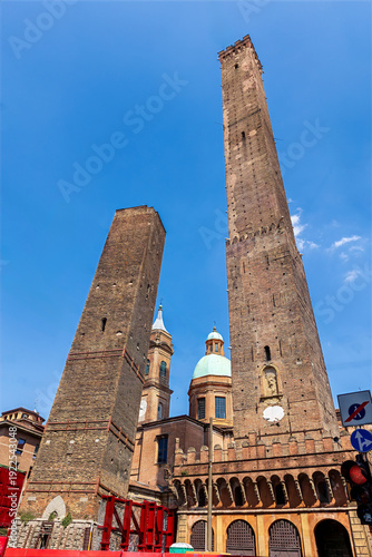 Wallpaper Mural The famous two towers are the symbol of Bologna. The Asinelli Tower (Torre degli Asinelli) is the taller tower on the right, and the Garisenda Tower (Torre Garisenda) is the shorter one. Torontodigital.ca