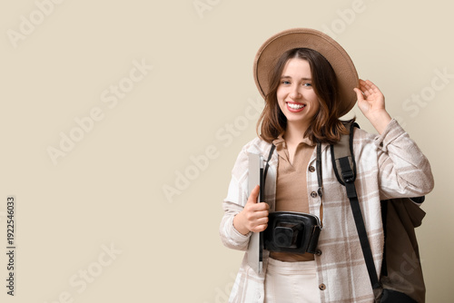 Female traveler on beige ba...