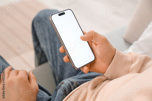 Young man with mobile phone...