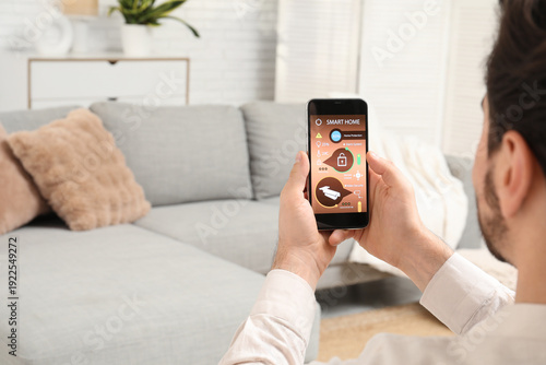 Young man using smart home ...