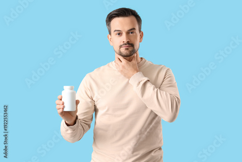 Handsome man with pill bott...