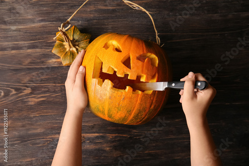 Woman with knife carving Ja...
