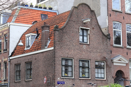 Canvas Print Historic Brick House Exterior with Bell Gable and Red Tiles Roof in Amsterdam, J