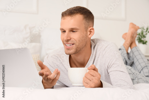 Young man with cup of coffe...
