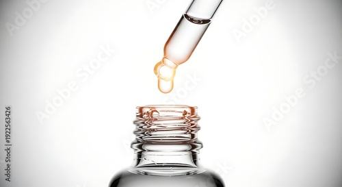 Close-up of a dropper dispensing a drop of liquid into a bottle, highlighting skincare and beauty products