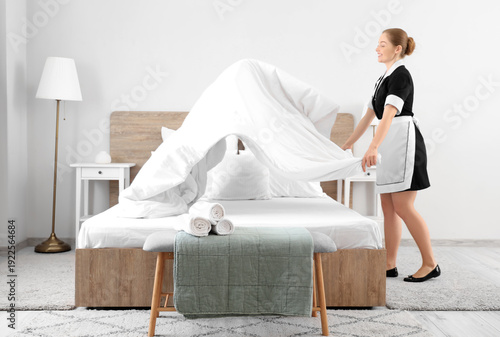 Young chambermaid making be...