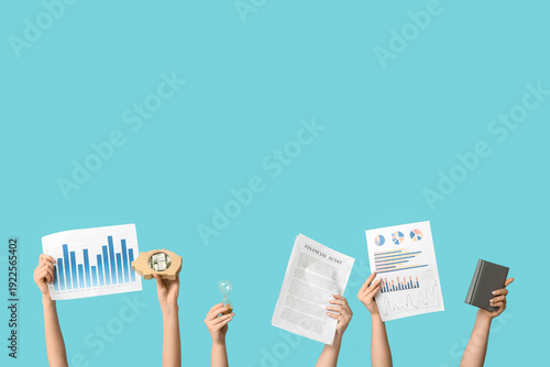 Female hands with financial graphics, document, notebook, hourglass and piggy...