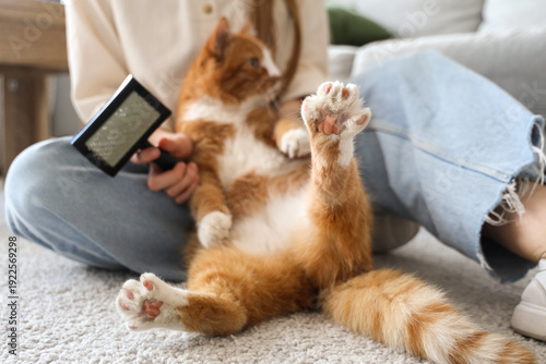Wallpaper Mural Woman with brush and cute cat sitting on floor at home, closeup Torontodigital.ca