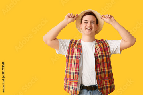 Young man in hat on yellow ...