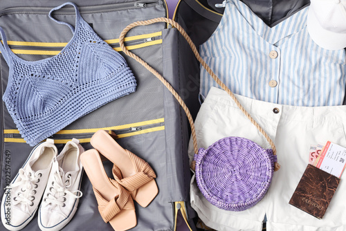 Open suitcase with belongin...