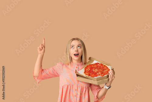 Young woman holding cardboa...