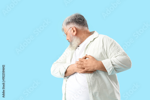 Senior man having heart att...