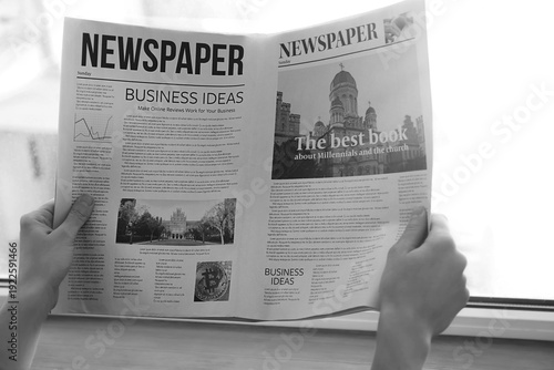 Young woman reading newspap...