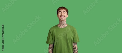 Smiling tattooed young man ...