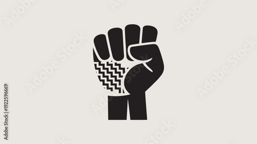 A powerful raised fist with a patterned wristband on a plain background