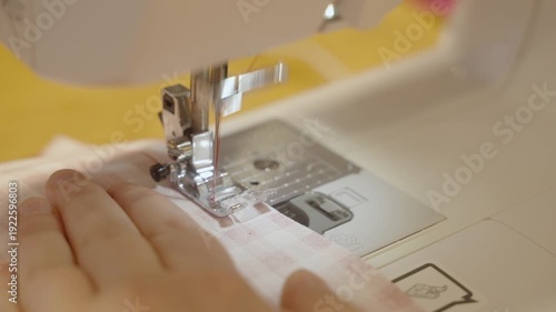 Sewing on a machine, close-up of needle and fabric