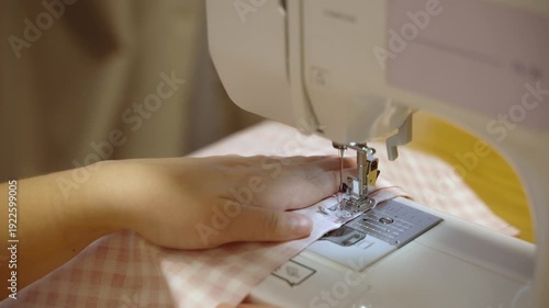 Sewing on a machine, close-up of needle and fabric