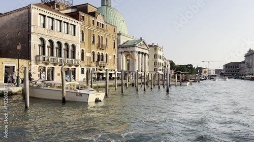 Venice canal journey: passing under historic bridge at sunset