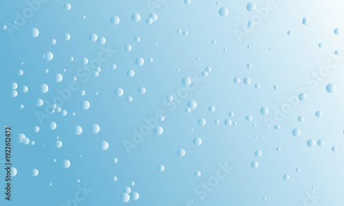 Rain drops on a glass window with a soft blue background