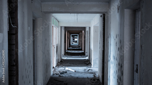 The doorless corridor of an old, abandoned building. The interior is gloomy and desolate.