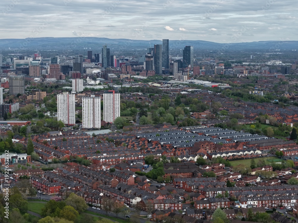 Fototapeta premium View of urban Manchester showing residential areas and skyline under a cloudy sky