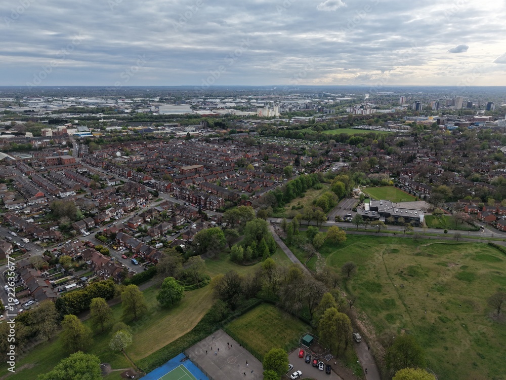 Fototapeta premium City skyline and suburban landscape captured from above during a cloudy afternoon in early spring