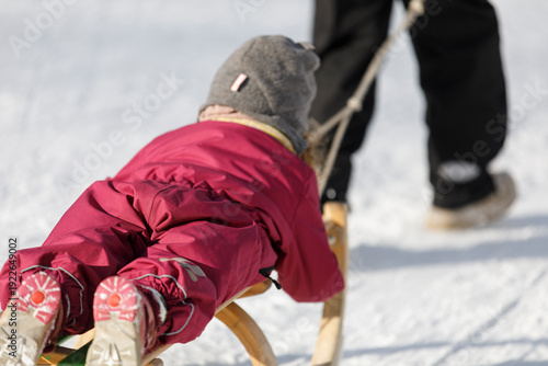 Happy child on a sled, wint...