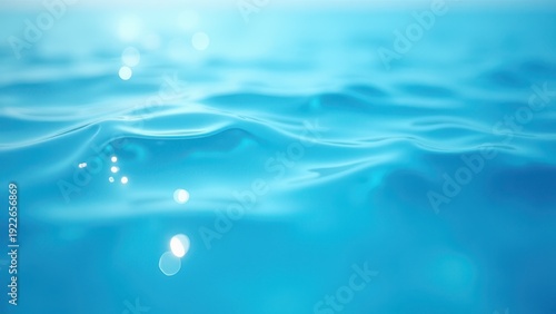 Blue water with ripples on the surface. Defocus blurred transparent blue colored clear calm water surface texture with splashes and bubbles. Water waves with shining pattern texture background.