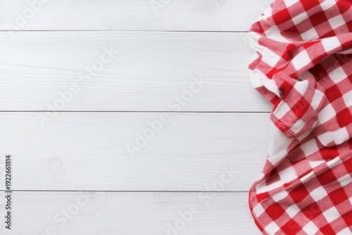 Red Gingham Tablecloth: A classic red and white gingham tablecloth, elegantly draped on a rustic wooden surface, creating a timeless and inviting atmosphere. 
