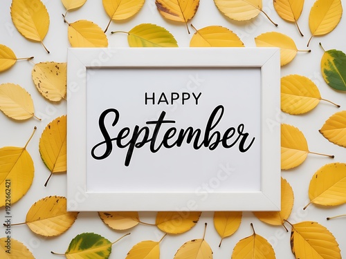Happy september text in a white frame surrounded by yellow and green autumn leaves on a white background