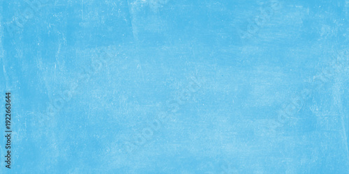 A vintage blue grunge paint texture creates a weathered paper backdrop with a rough aged surface and light watercolor pattern for a retro artistic wallpaper design