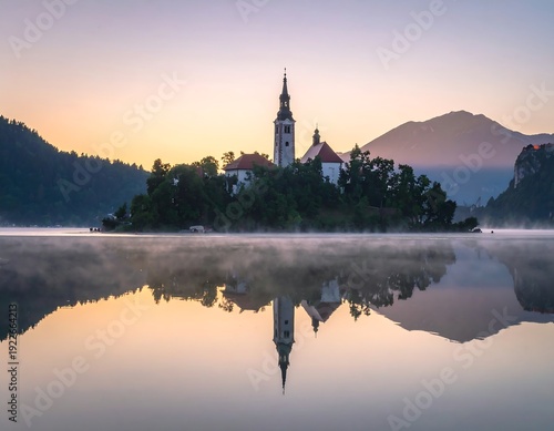 A serene lake scene with a church on an island at sunrise