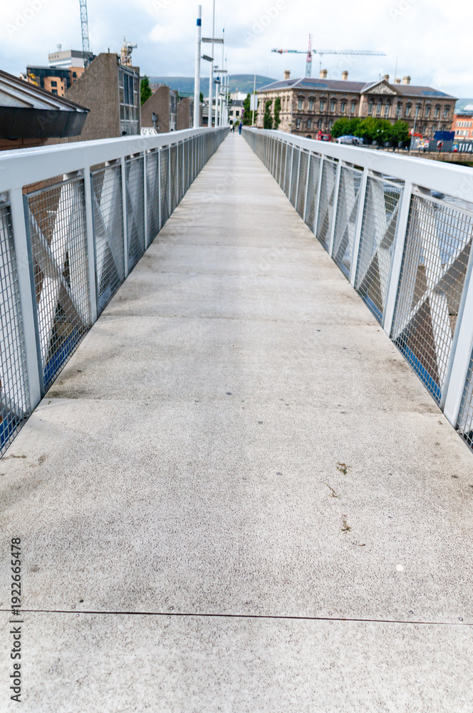 Obraz premium Pedestrian footbridge over a river with no people.
