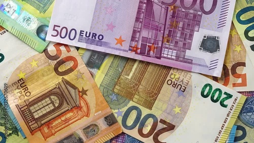 Close up fan shaped euro banknotes rotate spread out. Various denominations 10 20 50 100 200 500 euro cash. Economy banking finance investment success. European currency money background business