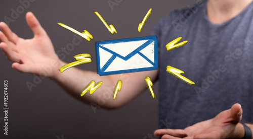 Hand holding email envelope...