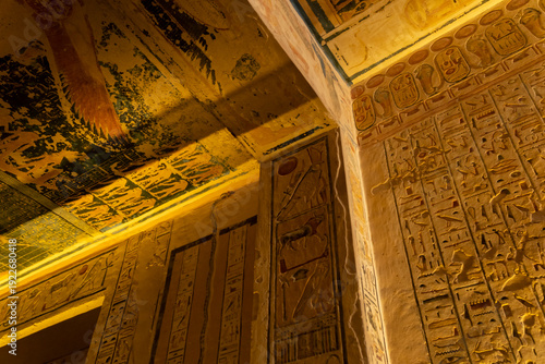 Ancient Egyptian hieroglyphs on the wall and ceiling of a tomb in the Valley of the Kings in Luxor.