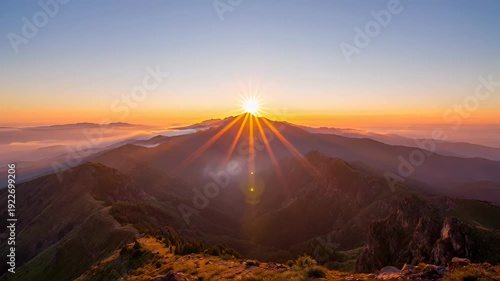 Sunrise over majestic mountain range with clouds at dawn - 4k video