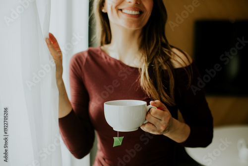 Woman holding a cup of tea ...