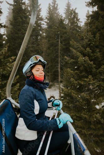 Woman riding a ski lift wit...