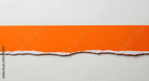 torn orange paper strip revealing edge detail on white background for design element usage