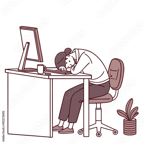 A man sitting at a desk with his head on the keyboard looking tired