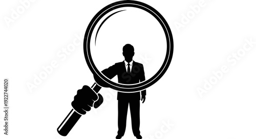Businessman standing with a magnifying glass examining details closely.