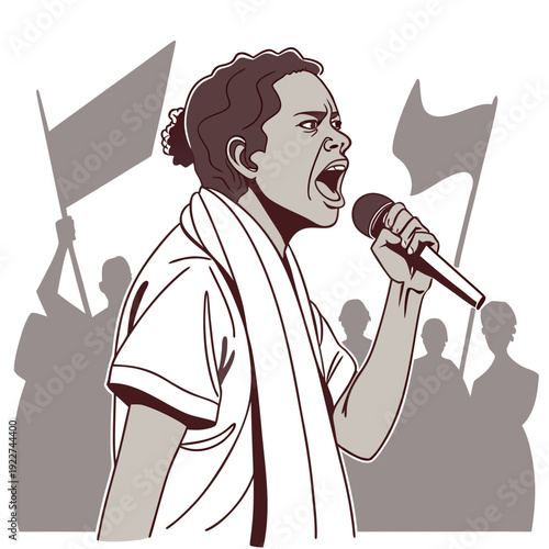 A woman speaks into a microphone with protest flags in the background