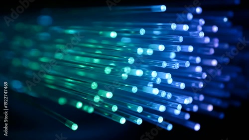 Close-up of glowing blue and green fiber optic cables.