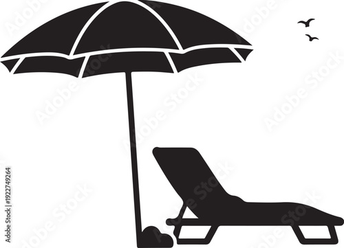 A black beach umbrella providing shade over a single lounge chair.